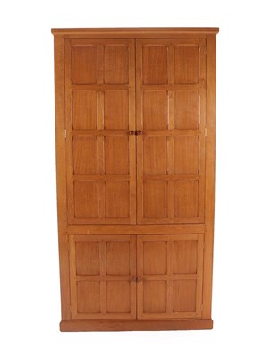 Lot 151 - Cat and Mouseman: Lyndon Hammell (Harmby): An English Oak Panelled Linen/Pantry Cupboard, with four