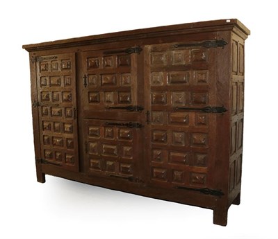Lot 170 - A Large Arts & Crafts Oak Linen Cupboard, adzed all over, with a rectangular top over two...