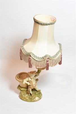 Lot 30 - A Royal Worcester blush ivory figural candlestick, model number 1365, with puce painted marks...
