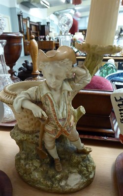 Lot 30 - A Royal Worcester blush ivory figural candlestick, model number 1365, with puce painted marks...