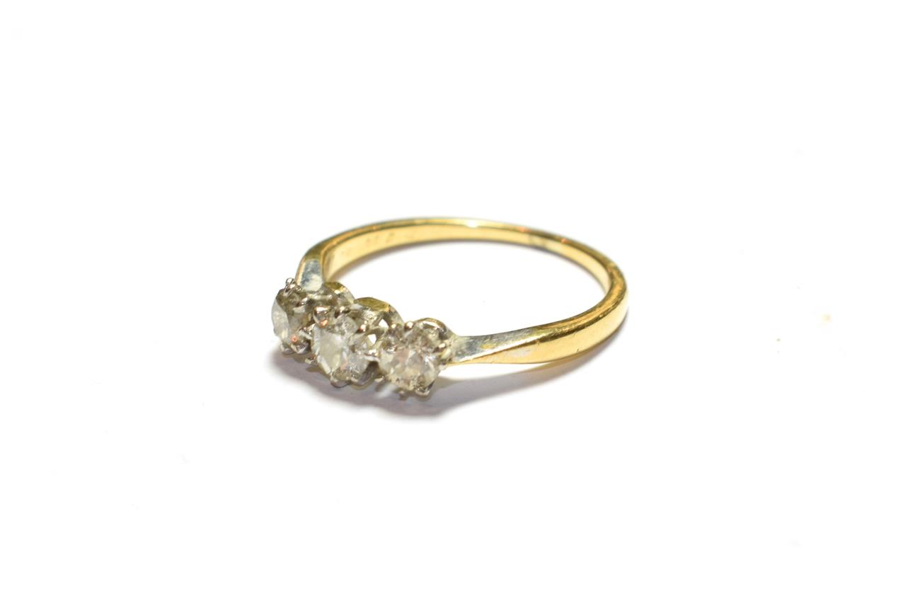 Lot 77 - A diamond three stone ring, stamped '18CT', finger size M