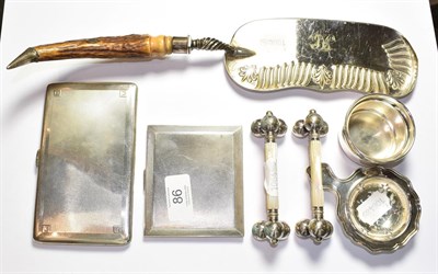 Lot 86 - Two silver cigarette cases, strainer and stand, two knife rests and a crumb scoop