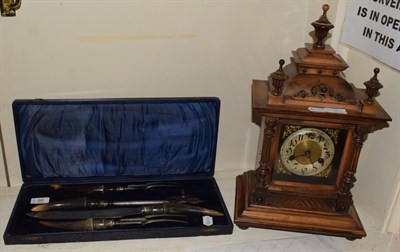 Lot 95 - A walnut striking mantel clock with German movement; together with a horn handled carving set...