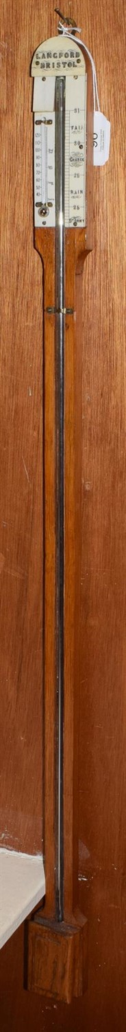 Lot 96 - A late 19th century oak stick barometer, single vernier dial, signed on a arched ivory plaque...