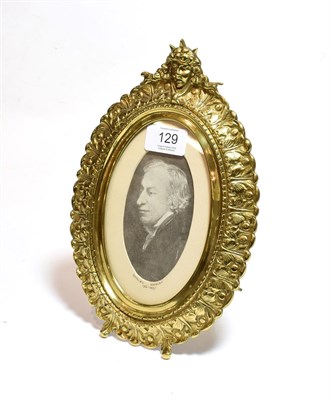 Lot 129 - A Victorian gilt brass easel-backed photograph frame, cast with leaves and surmounted by a...