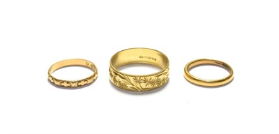 Lot 180 - Two 18 carat gold band rings, finger sizes L and V; and a 22 carat gold band ring, finger size I1/2