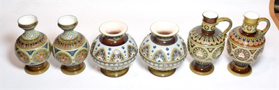 Lot 200 - Mettlach comprising two pairs of vases and a near pair of jugs, 20cm high, all with impressed marks