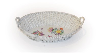 Lot 233 - A 20th century Meissen porcelain basket, with twin handles and painted with floral sprays, 25cm...