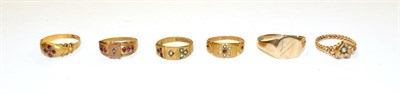 Lot 267 - Four 9 carat gold rings, various designs and sizes; a 9 carat gold signet ring (band cut); and...