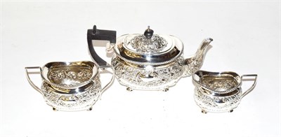 Lot 325 - A silver three-piece tea service, Birmingham marks, with ornate repousse decoration of scrolls...