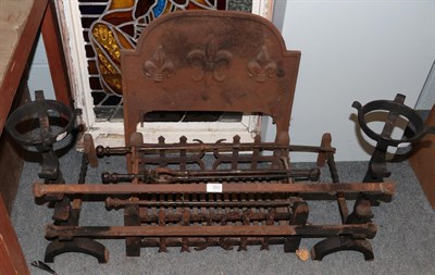 Lot 353 - A cast iron fire grate, andirons and tools, the grate decorated with fleur de lis