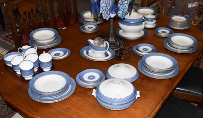 Lot 366 - A Wedgewood part dinner and tea service with decorative blue and gilt borders comprising soup...