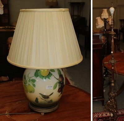 Lot 1119 - A wrought iron three branched standard lamp converted to electric and a gilt bezel, another...