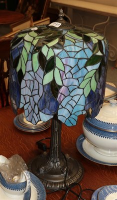Lot 1126 - A large Tiffany style table lamp, the shade decorated in blues and greens