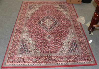 Lot 1132 - A machine made rug of Oriental design, together with another similar, 188cm by 151cm (2)