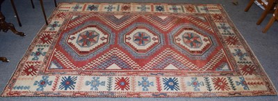 Lot 1134 - A Kozak Anatolian carpet, the terracotta field with three three octagons enclosed by cream borders