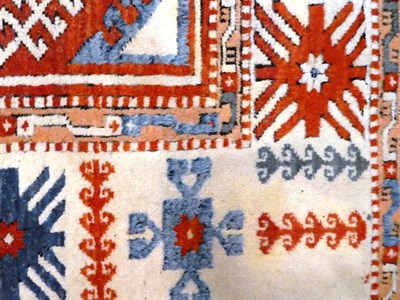 Lot 1134 - A Kozak Anatolian carpet, the terracotta field with three three octagons enclosed by cream borders