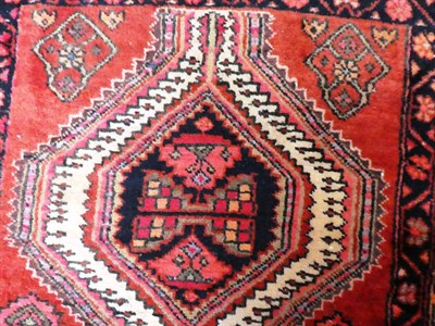 Lot 1137 - A Narrow Indian narrow runner, the brick red field of angular vines around a column of...