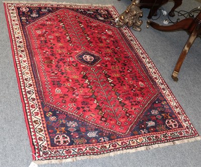 Lot 1139 - A Kashgai rug, the scarlet field centred by stepped medallion, frame by spandrels and narrow...