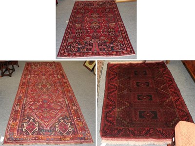 Lot 1149 - A Kashgai rug, the raspberry field of tribal motifs around a medallion framed by narrow...