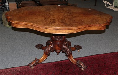 Lot 1160 - A 19th century quarter veneered walnut loo table, the shaped top above a pierced scroll carved...