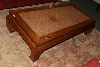 Lot 1173 - A 20th century Chinese hardwood coffee table with rattan top, 166cm wide by 86cm deep by 42cm high