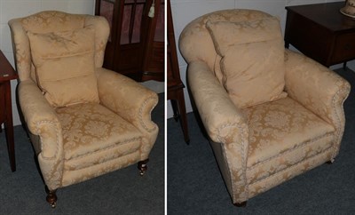 Lot 1178 - A wing chair upholstered in gold and cream fabric; together with a further armchair in matching...