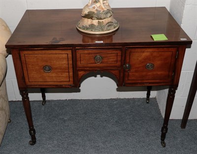 Lot 1180 - A 19th century inlaid mahogany side table, the central drawer over a small aperture with two scroll
