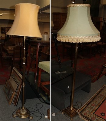 Lot 1229 - Two brass standard lamps, raised upon decorated claw feet