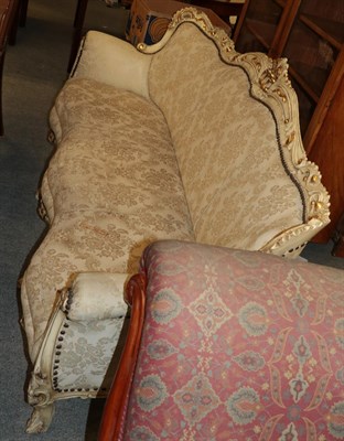 Lot 1258 - A serpentine front parcel gilt cream painted sofa, 192cm wide