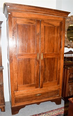 Lot 1266 - An 18th century French armoire with cupboard doors enclosing hanging space, with a deep drawer...