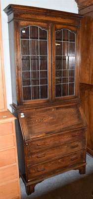 Lot 1267 - A 1920's oak bureau bookcase with leaded glass upper section, 94cm by 43cm by 210cm high