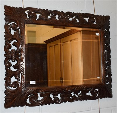 Lot 1269 - A carved oak and pierced mirror, 76cm by 94cm