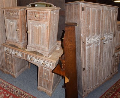 Lot 1273 - A limed oak five-piece bedroom suite, comprising wardrobe, dressing table, bed and pair of...