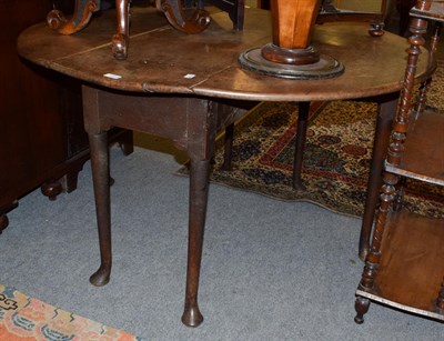 Lot 1284 - An 18th century mahogany drop-leaf table with pad feet, 130cm by 122cm by 71cm high