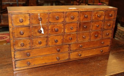 Lot 1288 - A 19th century table-top cabinet with twenty one small drawers and four larger ones to the...