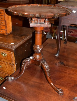 Lot 1289 - A George III style carved mahogany tripod table, the associated pie-crust top above a birdcage...