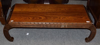 Lot 1292 - A Chinese coffee table with carved ends, 120cm by 48cm by 32cm high