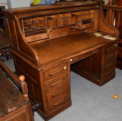 Lot 1303 - An early 20th century oak roll-top desk