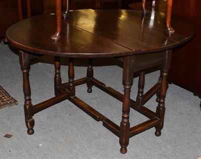 Lot 1317 - A 19th century oak drop leaf dining table, 139cm (open) by 108cm by 74cm high