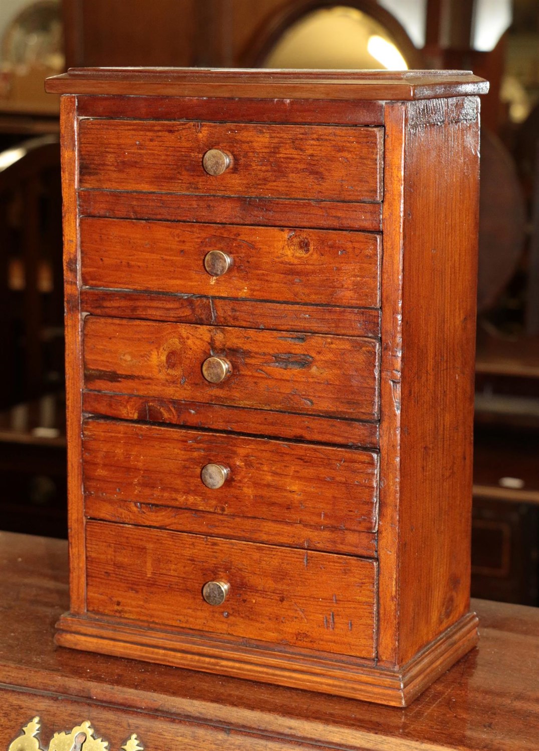 Lot 1324 - A 19th century miniature chest of five small drawers