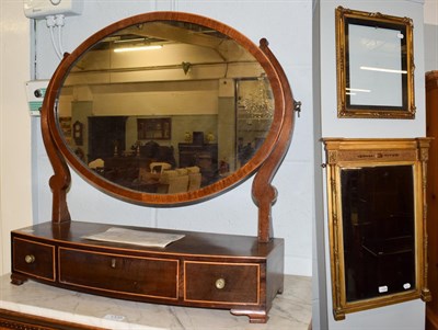 Lot 1334 - A Regency inverted breakfront gilt framed mirror, the bevelled rectangular plate flanked by...
