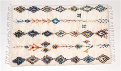 Lot 198 - Modernist Moroccan hand-knotted carpet, the high piled ivory field with columns of polychrome...