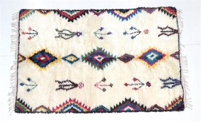 Lot 199 - Modernist Moroccan hand-knotted carpet, the high-piled ivory field with a column of polychrome...