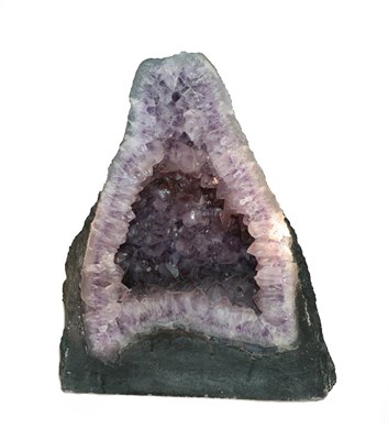Lot 2148 - Minerals: An Amethyst Geode Cathedral, probably Brazil, of squat form, 34cm by 20cm by 40cm, weight