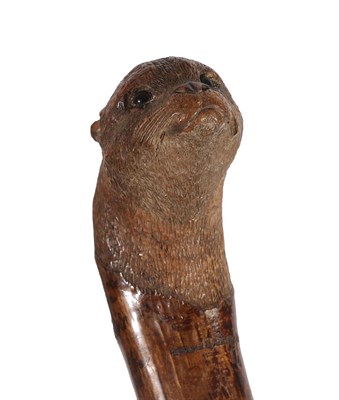 Lot 2150 - Hunting: A Carved Otter Pole, by Swaine & Adeney, London, the ash tree shaft terminating in a metal
