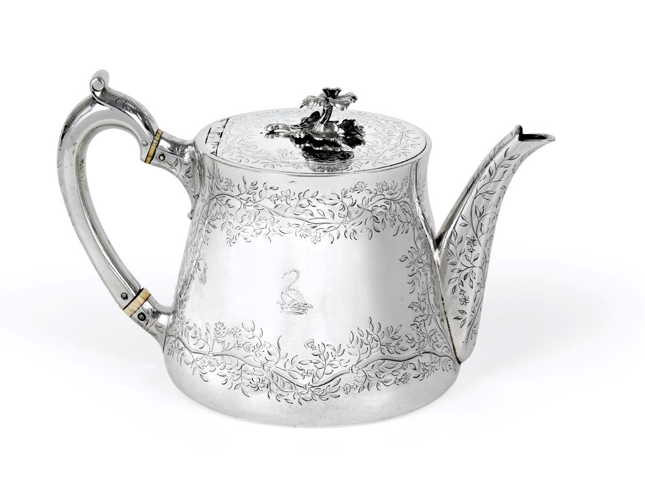 Lot 2067 - A Victorian Silver Teapot, by Robert Garrard, London, 1850, tapering and engraved with foliage, the