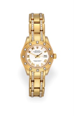 Lot 2159 - A Lady's 18 Carat Gold Diamond Set Automatic Calendar Centre Seconds Wristwatch, signed Rolex,...