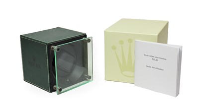 Lot 2196 - A Rolex Watch Winder, circa 2010, cube shaped winder with a hinged perspex door, single on/off...