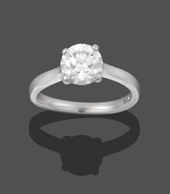 Lot 2208 - A Platinum Diamond Solitaire Ring, the round brilliant cut diamond in a four claw setting, on a...